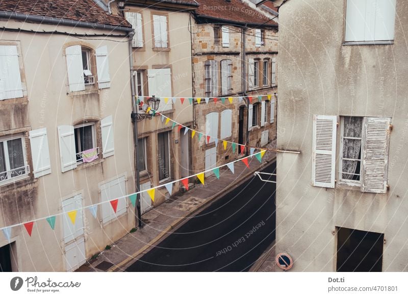 Street in France decorated with pennants for a holiday pennant chain flag houses shutters Adorned forsake sb./sth. Deserted Old building Street party Holiday