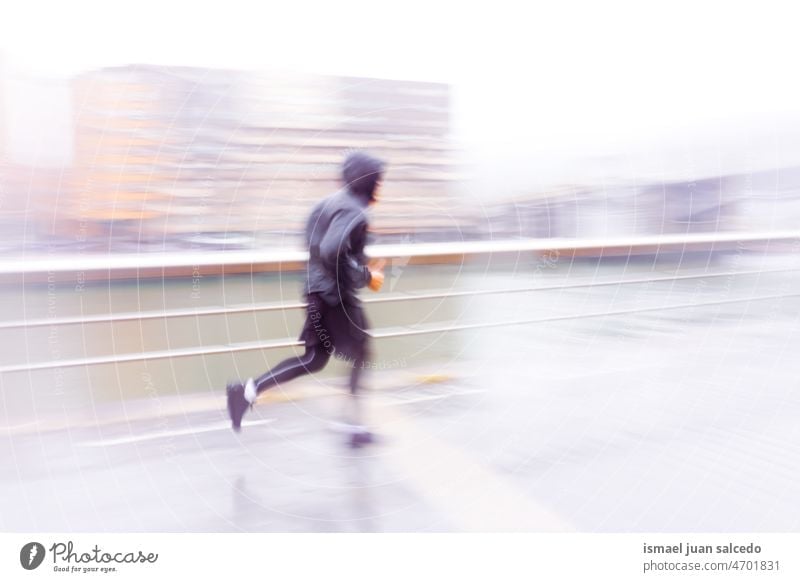 blurred adult man running on the street in Bilbao city, Spain marathon runner jogging action fitness health lifestyle jogger sport exercise athletic training