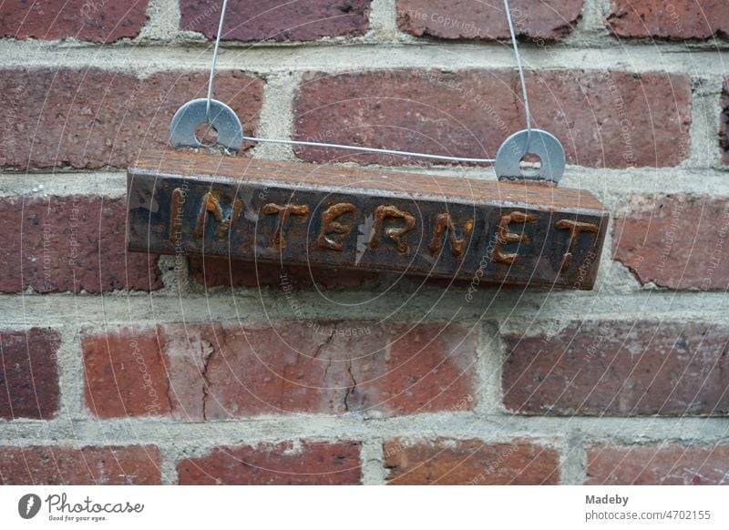 Rusty sign to the internet in front of an old factory wall made of red brick in the district Margaretenhütte in Gießen at the river Lahn in Hesse, Germany Stone