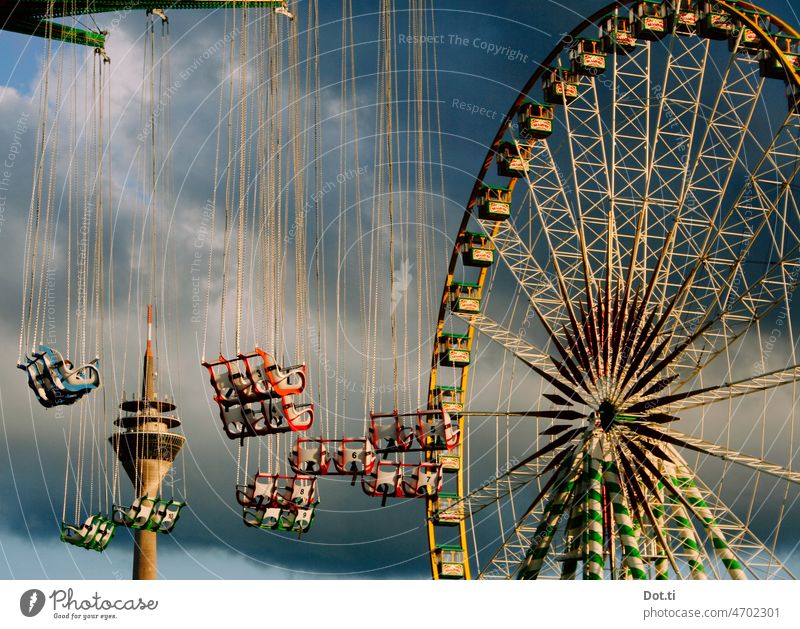 Carousels and Ferris wheel at the funfair in Düsseldorf Chairoplane Duesseldorf Television tower Shooting match Fairs & Carnivals Theme-park rides Exterior shot