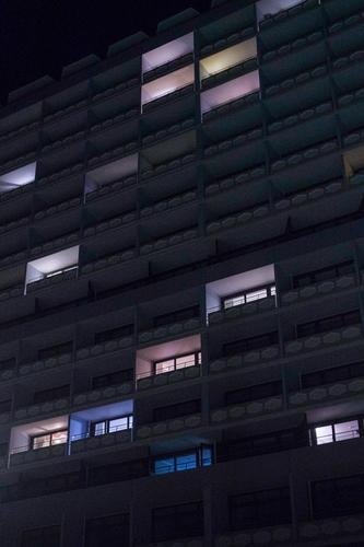 Pastel glowing windows in apartment facade at night Architecture Structures and shapes Abstract Light darkness Night House (Residential Structure) High-rise