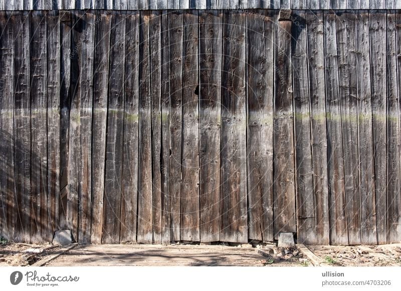 Natural, wooden, brown boards, wall of a barn, fence with branches, abstract textured background, empty underground. rustic old plank farm white earlier glaze