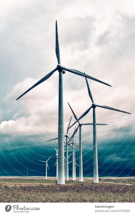 Wind turbines generating electricity in a stormy weather alternative blade blue cloud cloudy conservation cycle development ecology electrical energy