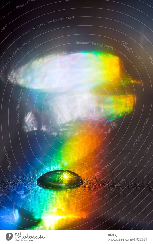 A rainbow colored water droplet in brightly colored environment Gaudy Prismatic colors Experimental Drops of water Reflection Light Colour noise Pure Purity