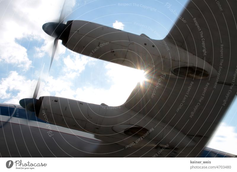 Wing on the aircraft of a propeller plane in the backlight of the sun Propeller Airplane propeller engine Propeller aircraft propeller blades Engine Machinery