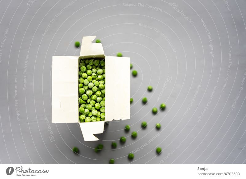 Frozen peas in a box on a gray background Peas Cardboard plan Gray Table Food Healthy Vegetable vegetarian Organic Green Cooking naturally more vegan Diet Raw