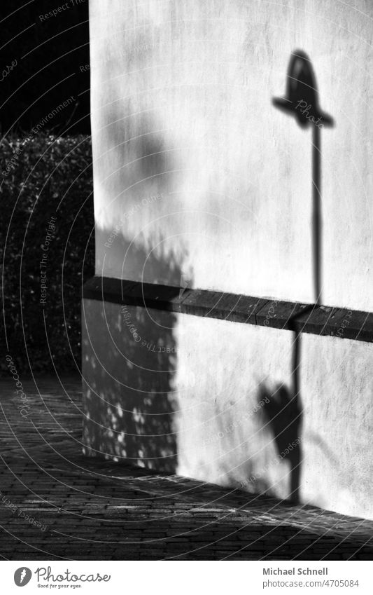 Shadow lantern on a house wall Black & white photo Black and white White Exterior shot Light low sun Shadow play shadow cast