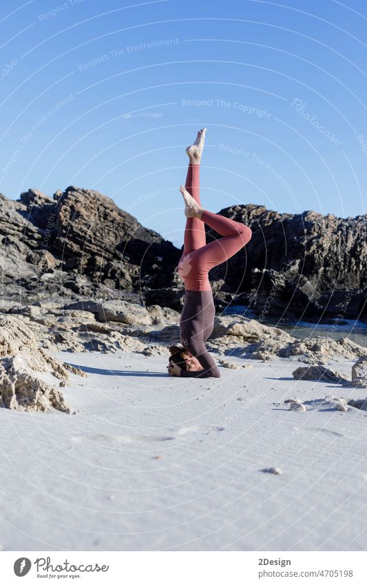 Young woman practice balance asanas on Summer yoga session on a beautiful beach at Formentera, Spain person relaxation sea exercise fitness sport body female