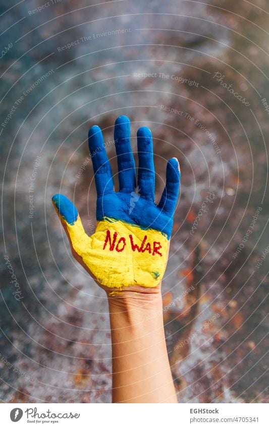 Female hand painted in the colors of the flag of Ukraine and blood. No war and peace concept. ukrainian flag independence poster support blue hands symbol