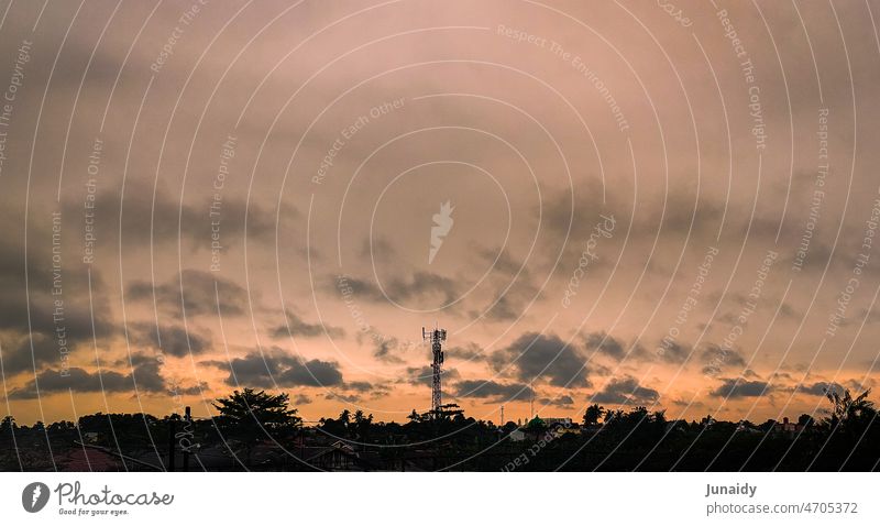 A telecommunication tower shot from far away in the evening with so cloudy background bright weather famous place modern downtown district tourism dark blue