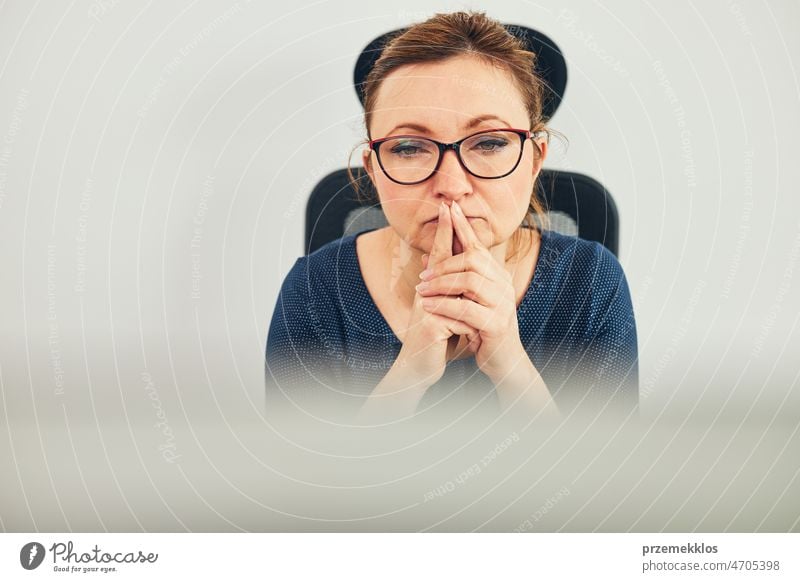 Woman entrepreneur focused on solving difficult work. Confused businesswoman thinking hard looking at computer screen frustration problem deadline
