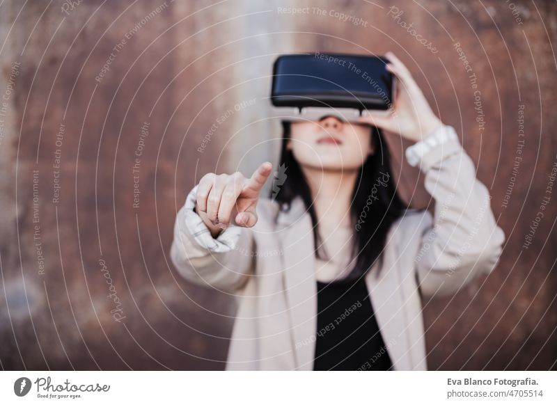 chinese Businesswoman using virtual reality headset. selective focus on hands. technology vr goggles meta verse attractive young game contraption lady smart