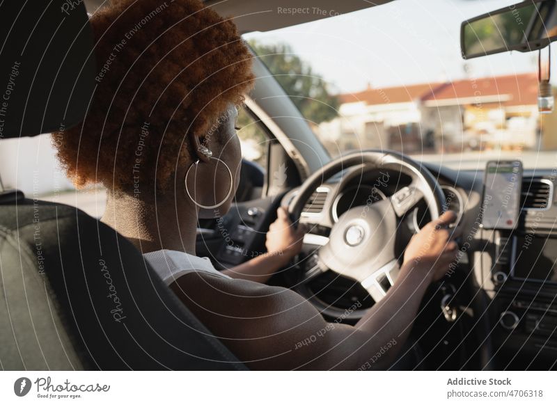 African American woman driving car in sunny day driver curly hair afro summer travel hairstyle black sit african american daytime relax seat automobile street