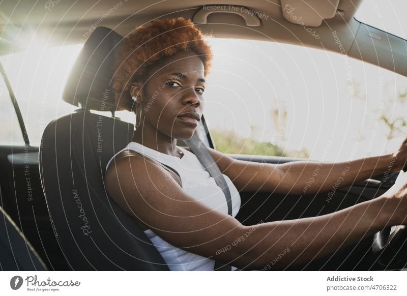 African American woman driving car in sunny day driver curly hair afro summer travel hairstyle black sit charming african american daytime relax seat automobile