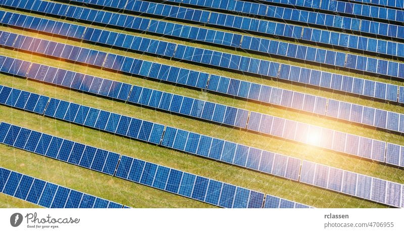 Aerial view of solar panels field drone alternative energy industry blue photovoltaic sun flare sunlight cell clean collector eco ecological ecology electric