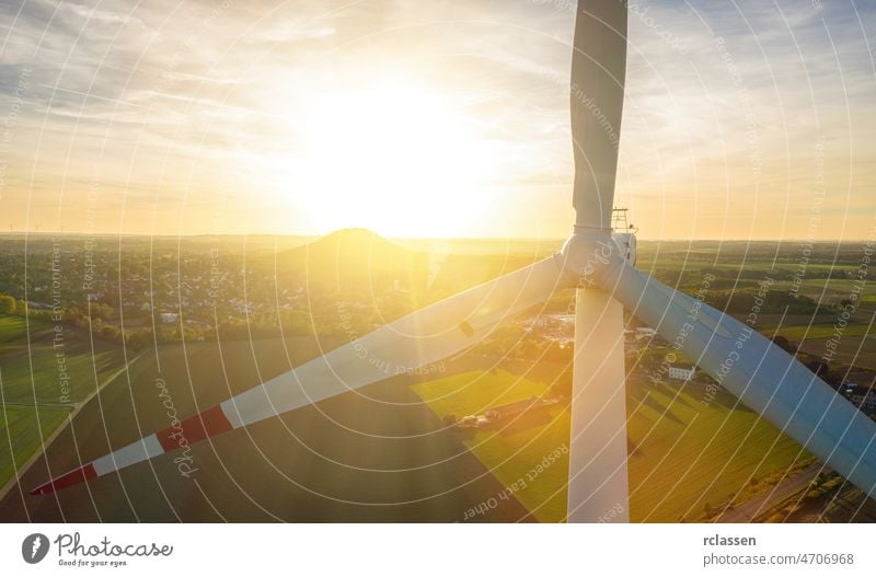 Beautiful sunset above the windmills on the field turbine energy power environment fuel alternative drone clean electricity global warming construction