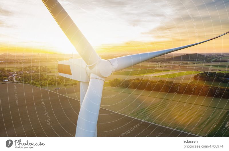 Wind turbines and agricultural fields on a summer day - Energy Production with clean and Renewable Energy - aerial shot wind energy power environment fuel