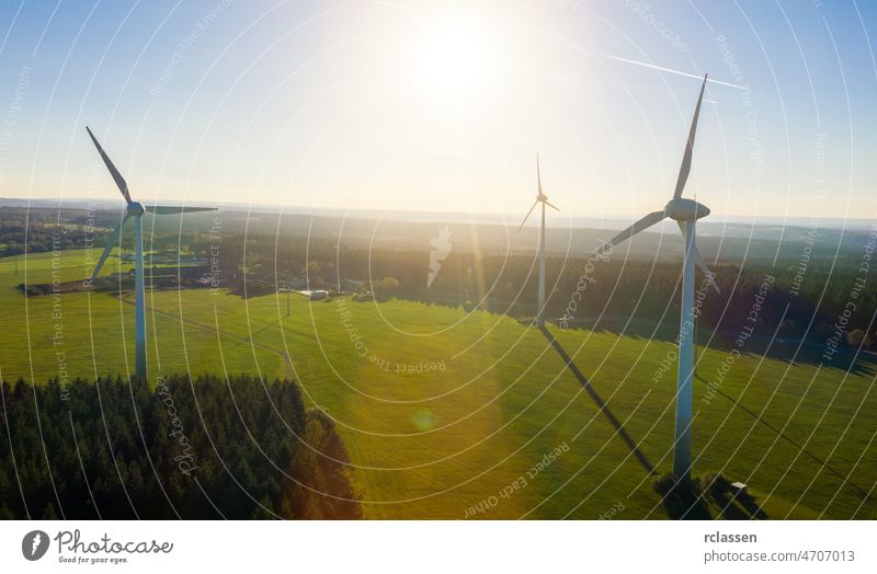 Wind turbines and agricultural fields on a summer day - Energy Production with clean and Renewable Energy - aerial drone shot wind energy power environment fuel