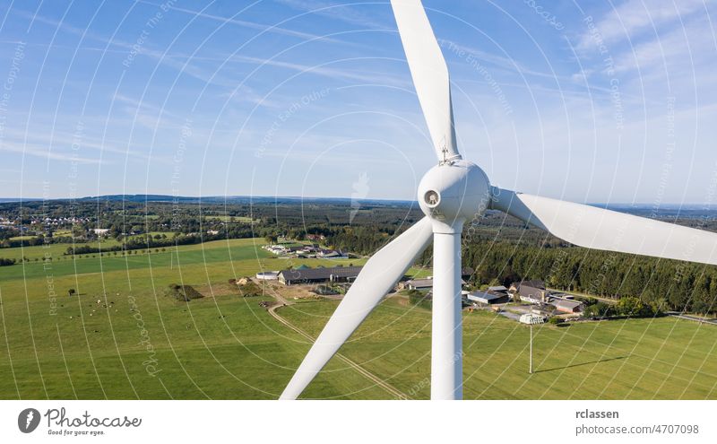 Wind turbines and agricultural fields on a summer day bleu sky - Energy Production with clean and Renewable Energy - aerial shot, copyspace for your individual text