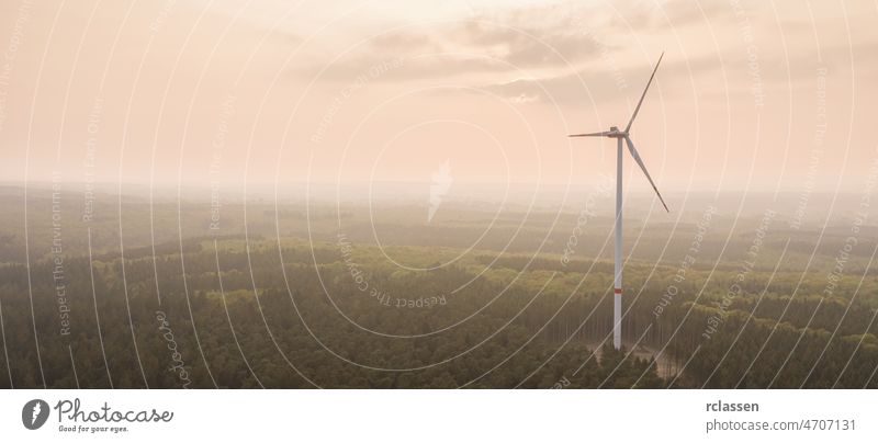 The mountain wind turbines in the sunrise and sunset of the clouds, copyspace for your individual text. energy fog power forest environment fuel mist green tree
