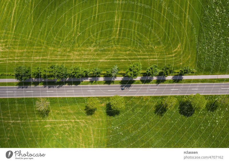 Aerial view of two lane road through countryside and cultivated fields. Drone shot and copy space for text drone freeway trip aerial view agricultural