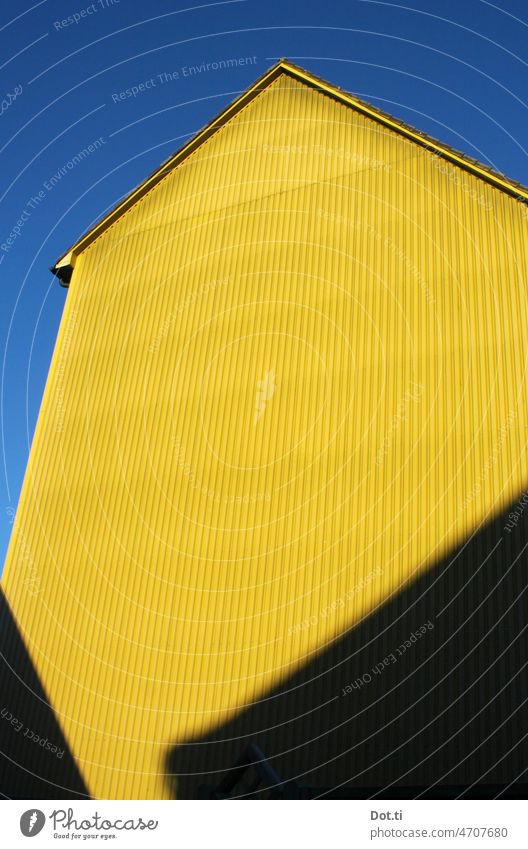 blue yellow facade Facade Cladding Corrugated sheet iron Sky Yellow Blue windowless Copy Space clear Portrait format Building Colour photo Deserted