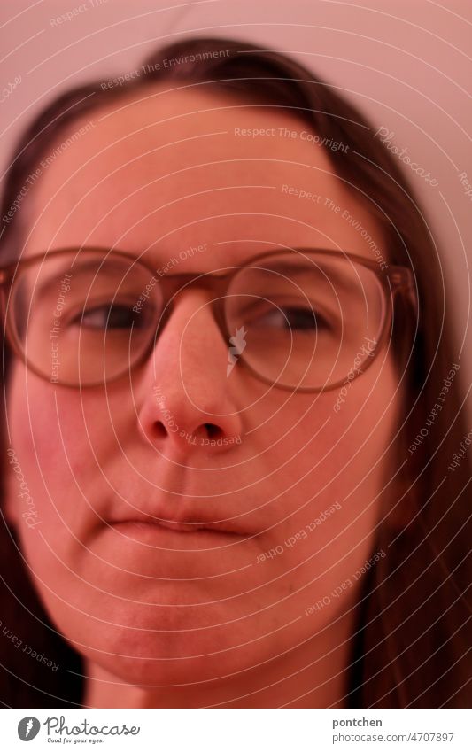 Face of a woman with glasses. A brooding, skeptical facial expression think skepticism Woman Mouth hostile communication portrait Close-up Think nasty common