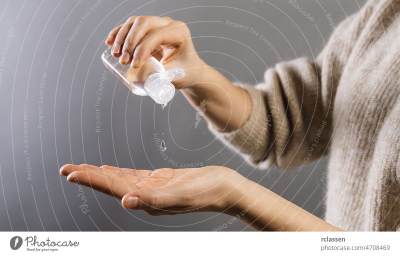 Hand sanitizer alcohol gel rub clean hands hygiene prevention of coronavirus virus outbreak. Woman using bottle of antibacterial sanitiser soap gel. dispenser
