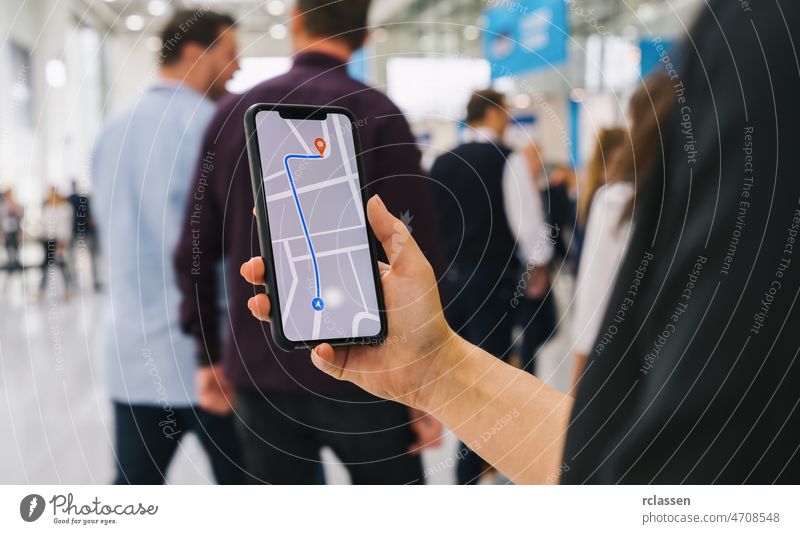 Visitor using GPS map navigation app on smartphone screen to get direction to destination address in the city, travel and technology concept image gps crowd