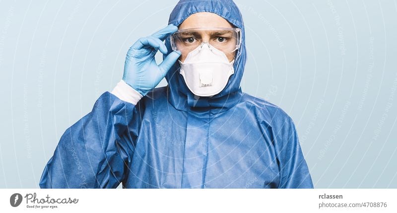 Doctor wearing protection Suit for Fighting Covid-19 (Corona virus) SARS infection Protective Equipment (PPE) with N95 or ffp3 mask. nurse doctor glasses n95