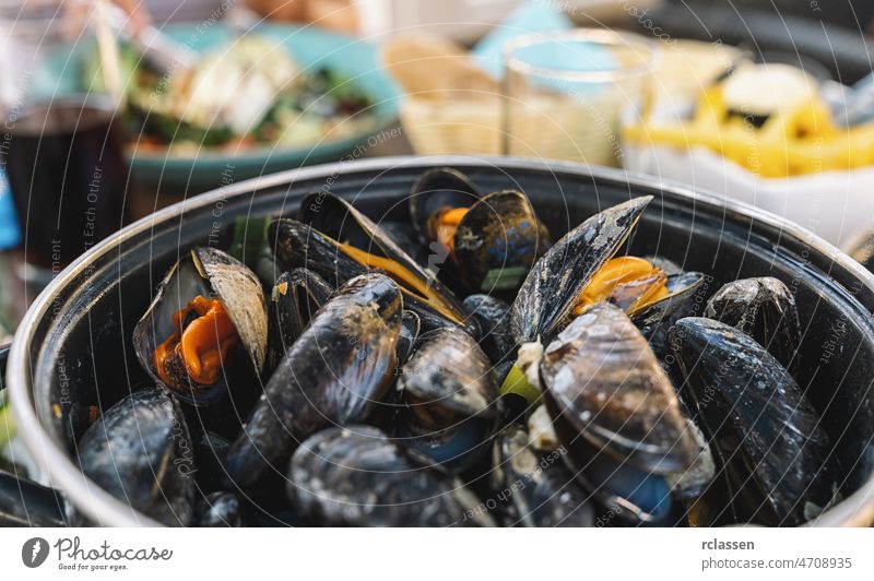 Mussels in a bowl with French fries on a restaurant.  A classic dish in Belgium, France and Netherlands. mussels background seafood belgium dutch bowl of food