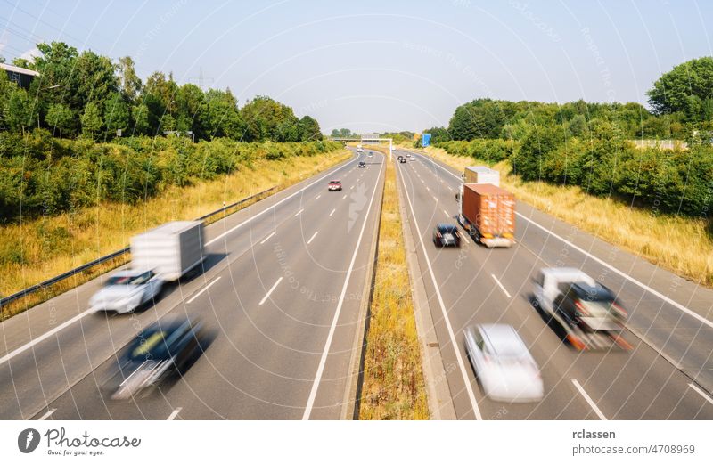 Lots of Trucks and cars on a Highway - transportation concept truck highway crowded freight automobile trailer delivery asphalt automotive blue blur business