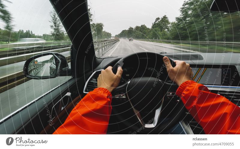 Driving car at a rainy day on a highway - POV, first person view shot traffic pov commute autumn jam stress auto asphalt dashboard wet crash hand wheel accident