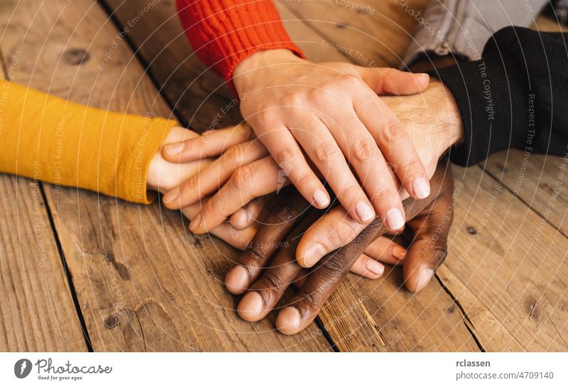 Diverse hands are join together on the wooden table diverse children youth teamwork community people support childhood family partnership adolescence