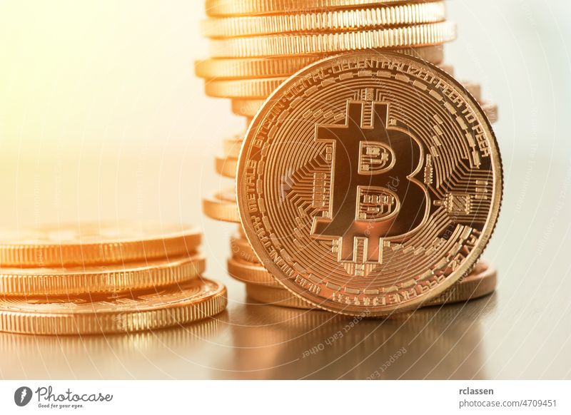 Golden Bitcoins on a gold background .Photo (new virtual money ) bitcoin crypto business symbol concept sign web metal exchange internet economy finance market