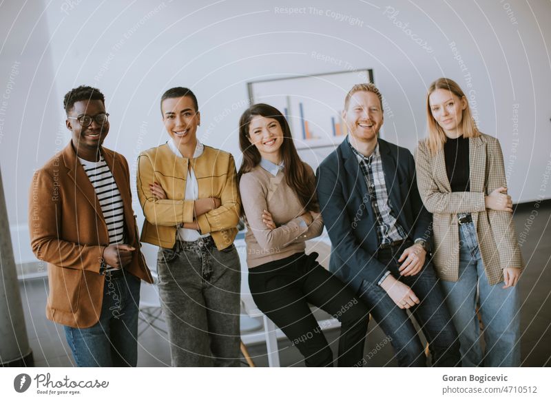 Group of positive businesspeople standing together in the office business meeting business people modern office office interior office team team meeting adult