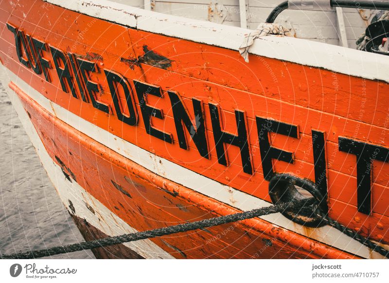 Berth for ship SATISFACTION Name Contentment Watercraft moored Site Longitudinal Orange Capital letter Dew Port side Old Detail Surface of water Hull Maritime