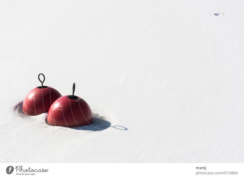 Two red buoys in the snow. With eyelet and their shadows. Eyelet Ring Snow two Round Shadow Untouched frozen Red Winter