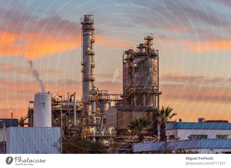 Installations of an oil refinery at sunset industry factory plant gas industrial pollution pipe chimney power energy chemical smoke tower fuel environment