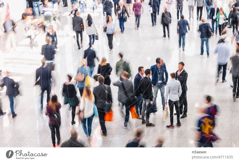 blurred people in a modern hall crowd commute convention business airport booth sale congress anonymous conference banner commercial commuters crowded economy