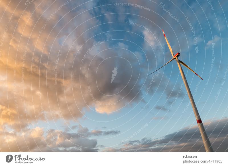 wind turbine against cloudy sunset sky windmill wind power renewable energy electricity power plant nature green energy ecology wind farm technology Industry