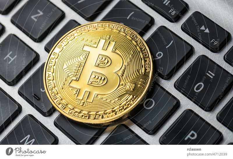 Golden Bitcoin on notebook bitcoin currency crypto money virtual gold litecoin business symbol etc bit-coin eth concept keyboard ethereum metal exchange