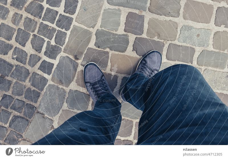 Young man standing in at the street in a oldtown in casually dressed sneakers, Point of view shot pov people lifestyle point summer way caucasian close-up young