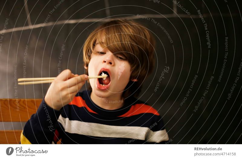 Child eats with chopsticks Eating Chinese Rice Infancy Boy (child) food Food Asian Dinner Meal background Delicious Chopstick Dish Healthy Fresh Concentrate Aim