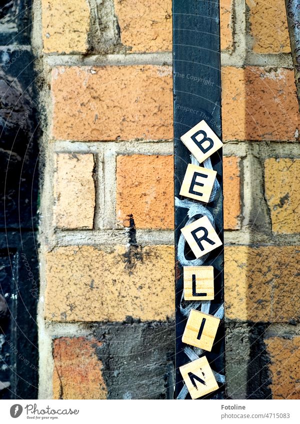 On small wooden squares are the letters BERLIN Berlin Letters (alphabet) Word Characters Wall (building) Wall (barrier) Facade Sign Exterior shot writing