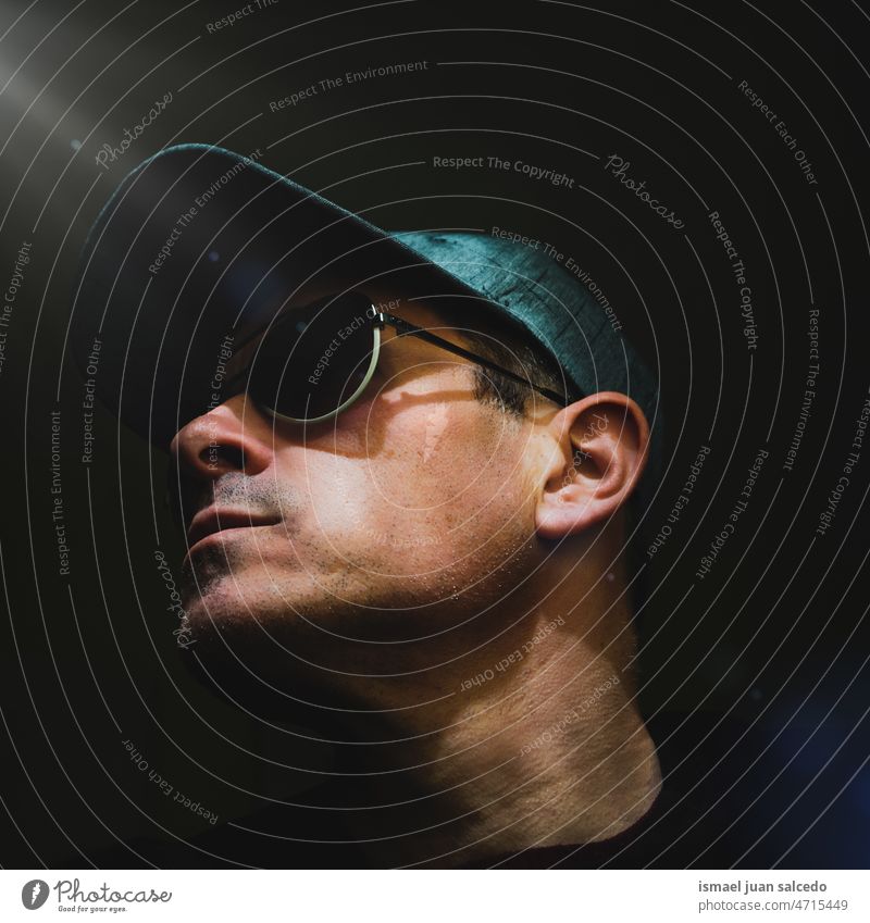adult man taking a selfie in the shadows one person portrait forty forties face head sunglasses cap male 40 years daytime casual style free time lifestyle