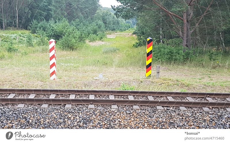 boundless Germany Poland railway tracks Railroad tracks rails Forest Meadow trees Nature Border Transport International Exterior shot Deserted Bollard Mark