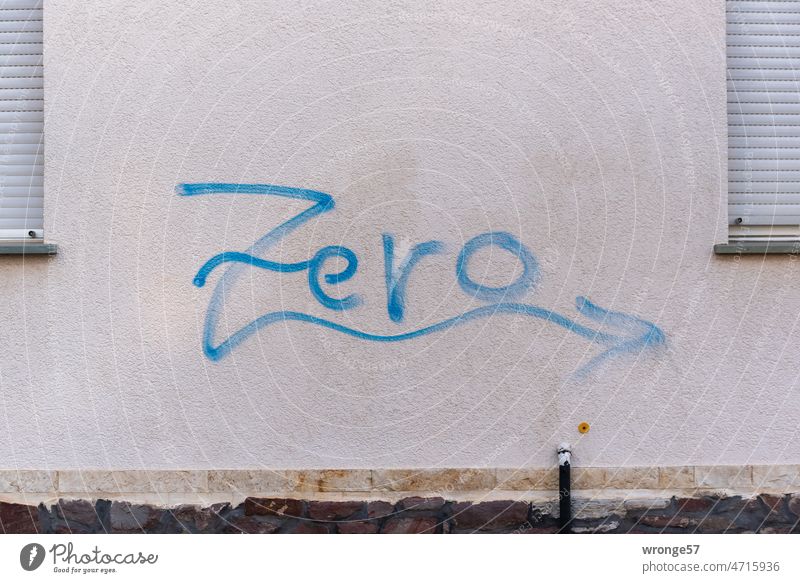 Zero | graffito sprayed with blue paint between two windows on a house wall zero Graffito Wall (building) Graffiti Daub Youth culture Characters Subculture