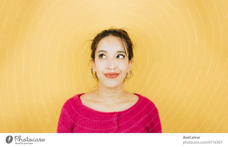 Young african woman funny expression hands on cheeks surprised, cute and  modern posing isolated over pink color wall background. Daily expressions  with copy space in studio. - a Royalty Free Stock Photo