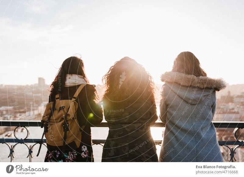 Three happy friends Porto bridge sightseeing at sunset. Travel, friendship and Lifestyle women city urban 30s travel together portuguese tour tourism woman